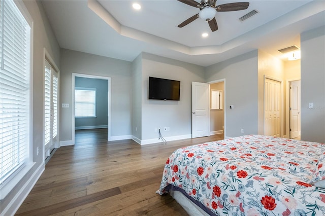 13209 SW 3rd Ln, Newberry, FL 32669 - bedroom featuring wood finished floors, a tray ceiling, baseboards, recessed lighting, and a ceiling fan