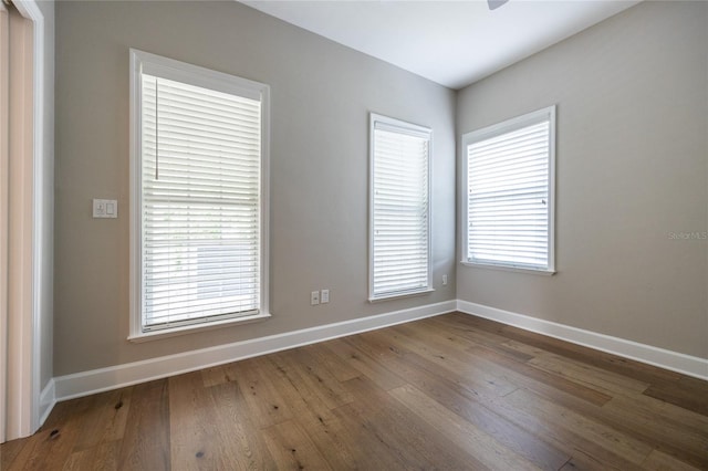 13209 SW 3rd Ln, Newberry, FL 32669 - unfurnished room featuring baseboards, wood finished floors, healthy amount of natural light, and a ceiling fan