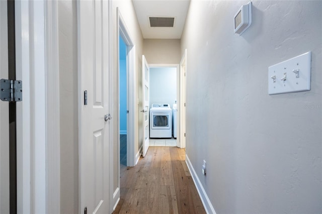 13209 SW 3rd Ln, Newberry, FL 32669 - corridor featuring washer / clothes dryer, light wood-style floors, and baseboards
