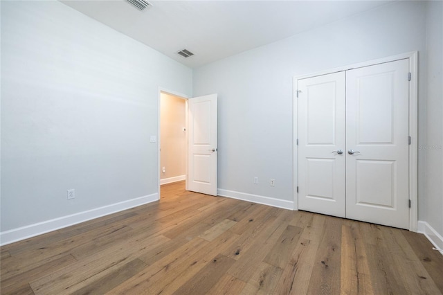 13209 SW 3rd Ln, Newberry, FL 32669 - unfurnished bedroom featuring light wood-style floors, baseboards, and a closet
