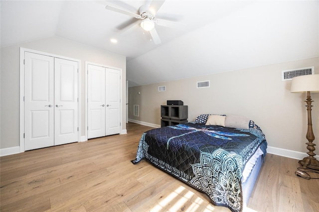 13209 SW 3rd Ln, Newberry, FL 32669 - bedroom featuring lofted ceiling, two closets, baseboards, wood finished floors, and ceiling fan