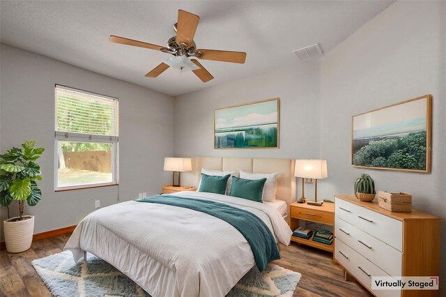 bedroom featuring wood finished floors, baseboards, and ceiling fan