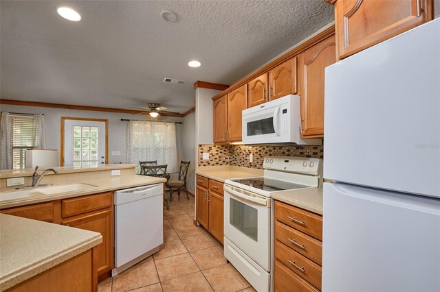 kitchen with white appliances, a sink, ornamental molding, decorative backsplash, and light tile patterned floors