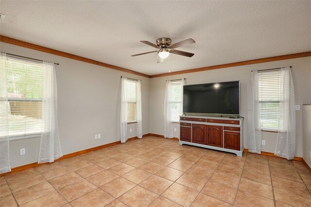 unfurnished living room with a ceiling fan, ornamental molding, baseboards, light tile patterned floors, and a textured ceiling
