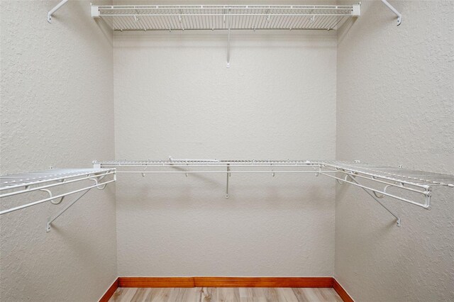 spacious closet with wood finished floors
