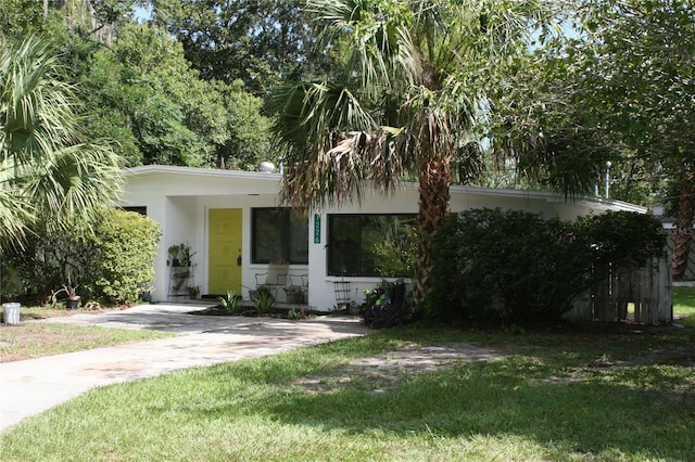 1226 NE 17th Ave, Gainesville, FL 32609 - view of front of house featuring a front lawn and stucco siding