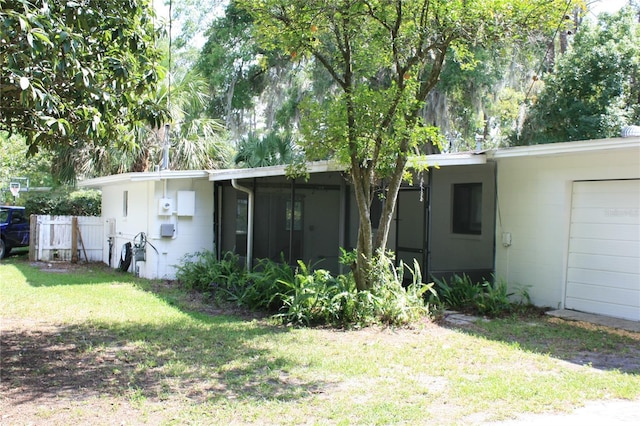 1226 NE 17th Ave, Gainesville, FL 32609 - back of property featuring concrete block siding and a yard