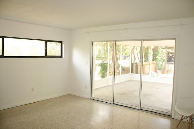 1226 NE 17th Ave, Gainesville, FL 32609 - empty room with speckle patterned floor and baseboards