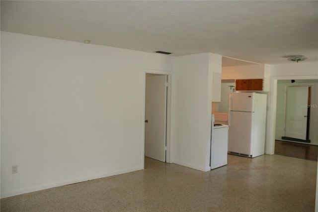 1226 NE 17th Ave, Gainesville, FL 32609 - spare room featuring dark aggregate flooring and baseboards