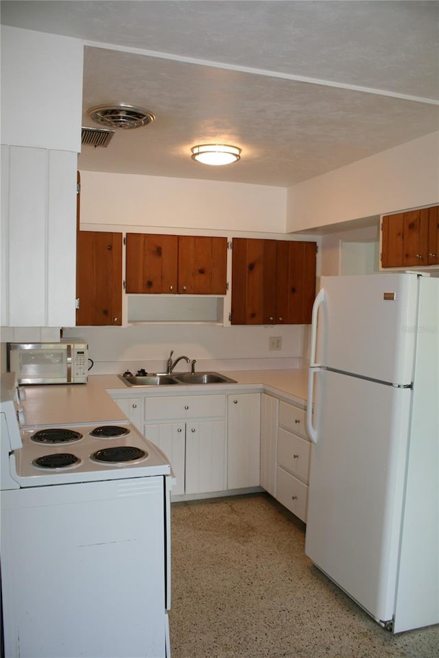 1226 NE 17th Ave, Gainesville, FL 32609 - kitchen featuring white appliances, light countertops, and white cabinetry