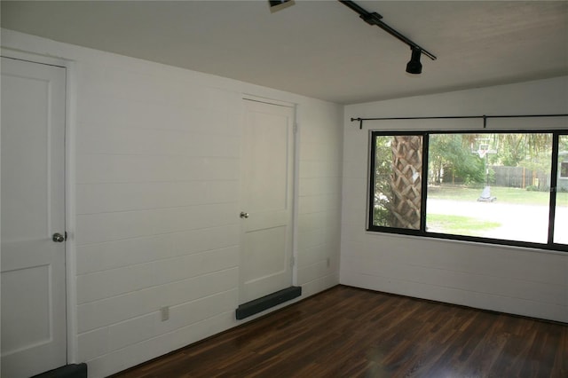 1226 NE 17th Ave, Gainesville, FL 32609 - unfurnished bedroom featuring dark wood-type flooring and track lighting