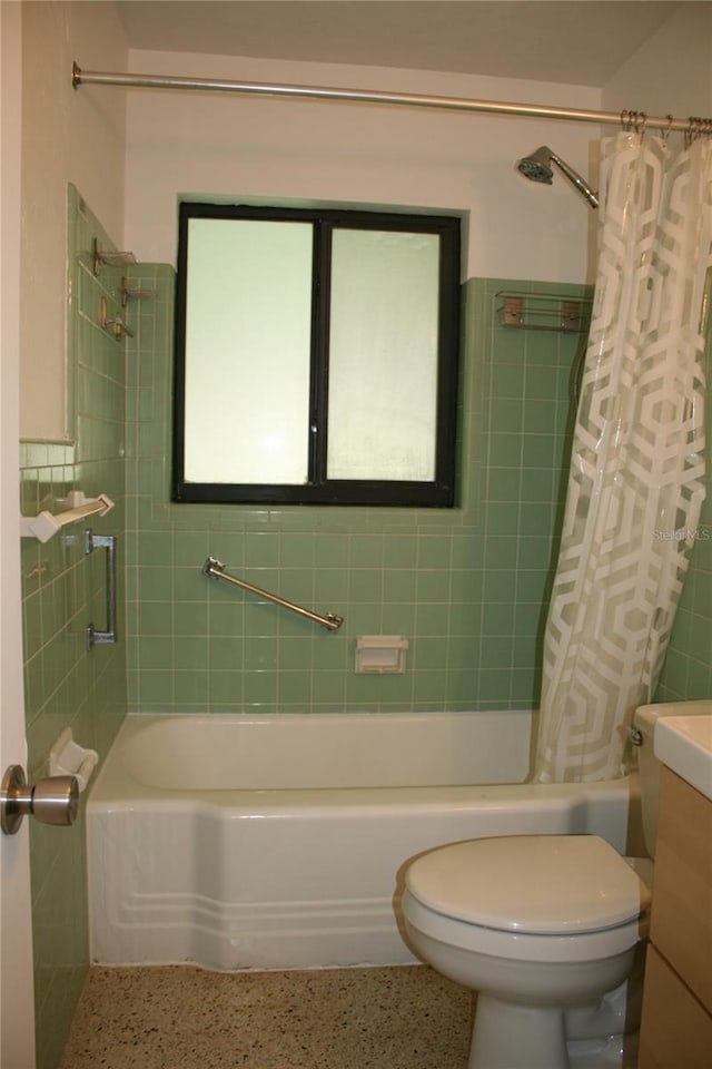 1226 NE 17th Ave, Gainesville, FL 32609 - full bathroom featuring shower / tub combo with curtain, speckle patterned floor, vanity, and tile walls