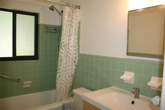 1226 NE 17th Ave, Gainesville, FL 32609 - full bath with shower / bath combo, vanity, tile walls, and a wainscoted wall