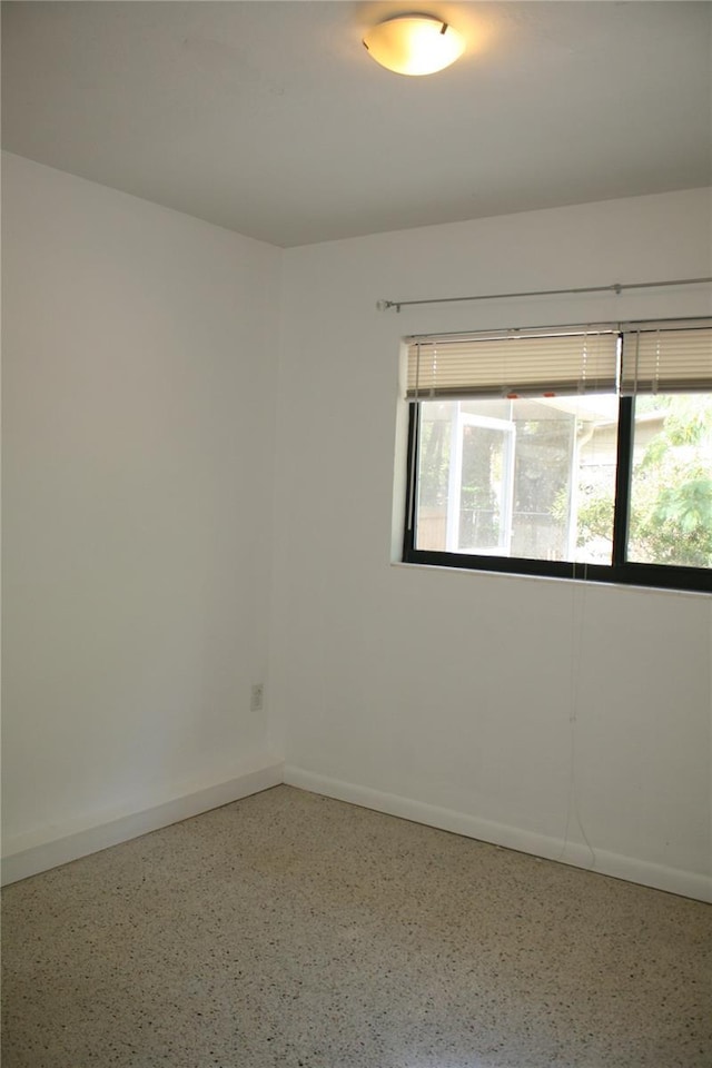 1226 NE 17th Ave, Gainesville, FL 32609 - spare room with speckle patterned floor and baseboards