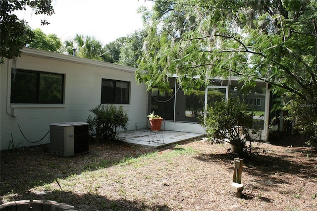 1226 NE 17th Ave, Gainesville, FL 32609 - back of house with concrete block siding and a patio area