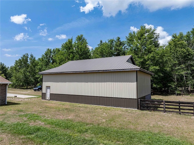 view of side of property featuring an outbuilding and metal roof