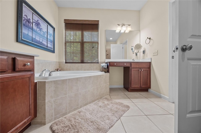bathroom with tile patterned floors, a garden tub, and vanity