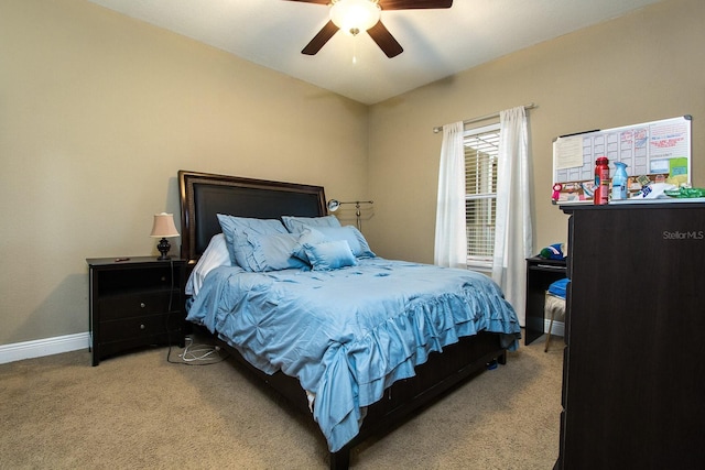 bedroom featuring light carpet, baseboards, and a ceiling fan