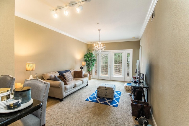 living area with carpet flooring, a chandelier, ornamental molding, french doors, and a textured wall