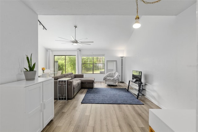 living room with ceiling fan and light wood finished floors