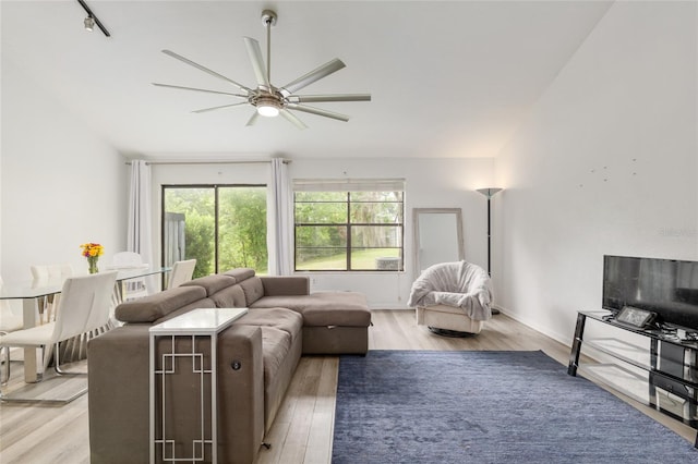 living area with ceiling fan and light wood-type flooring