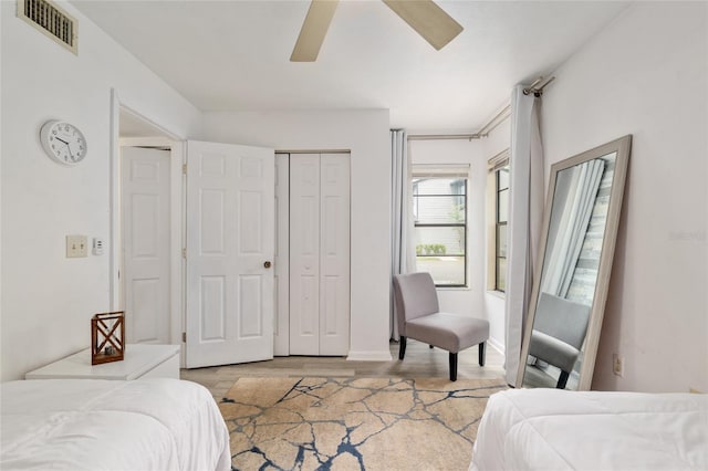 bedroom featuring wood finished floors, a closet, ceiling fan, and baseboards