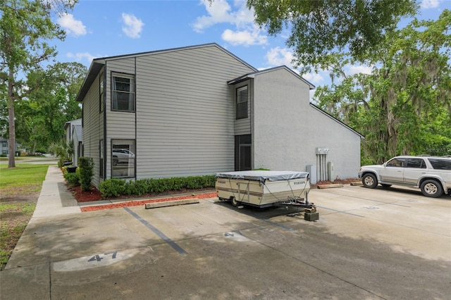 view of home's exterior featuring uncovered parking