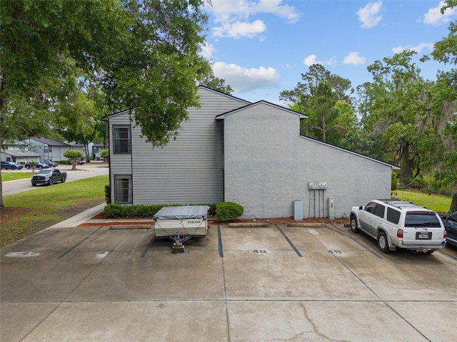 view of side of property with uncovered parking