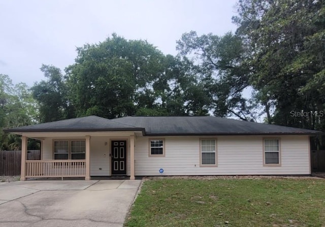 ranch-style home with a porch and concrete driveway
