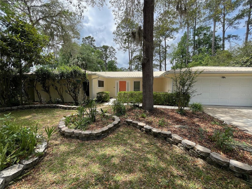 3514 NW 40th St, Gainesville, FL 32606 - ranch-style house with an attached garage and concrete driveway