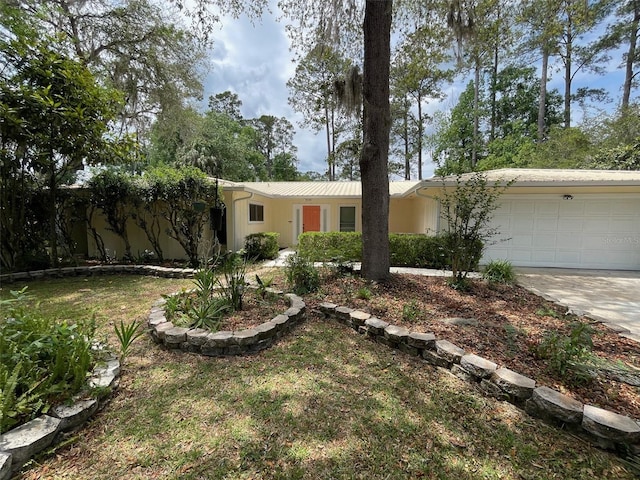 3514 NW 40th St, Gainesville, FL 32606 - ranch-style house with an attached garage and concrete driveway