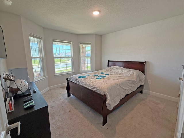15835 NW 123rd Ave, Alachua, FL 32615 - bedroom with light carpet, a textured ceiling, and baseboards