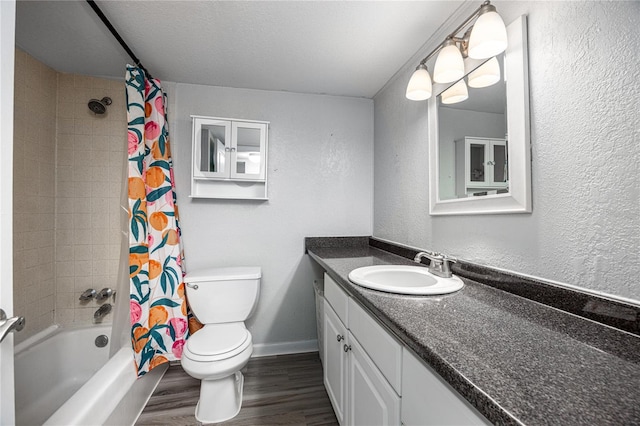 507 NW 39th Rd Unit 235, Gainesville, FL 32607 - full bath featuring toilet, wood finished floors, vanity, shower / bath combo, and baseboards