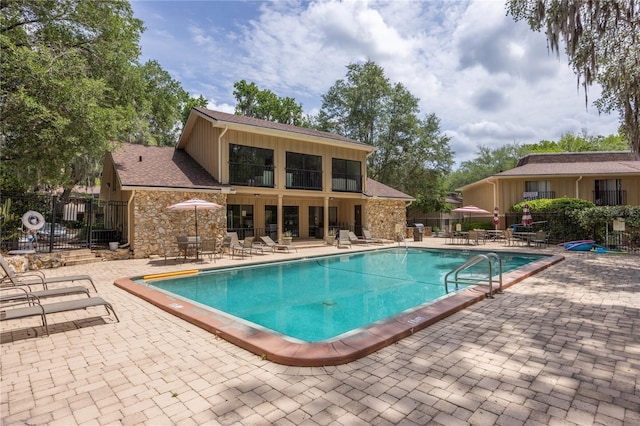 507 NW 39th Rd Unit 235, Gainesville, FL 32607 - community pool with fence and a patio area