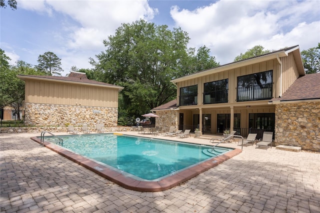 507 NW 39th Rd Unit 235, Gainesville, FL 32607 - community pool featuring a patio