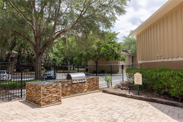 507 NW 39th Rd Unit 235, Gainesville, FL 32607 - view of patio featuring an outdoor kitchen, fence, and grilling area