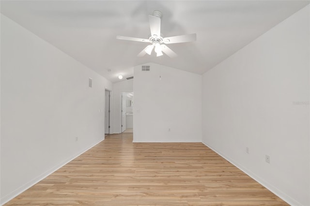 unfurnished room with ceiling fan, light wood-type flooring, lofted ceiling, and baseboards