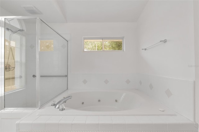 full bath with a shower stall and a whirlpool tub