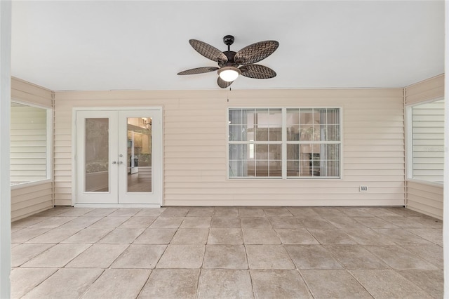 unfurnished sunroom featuring french doors and a ceiling fan