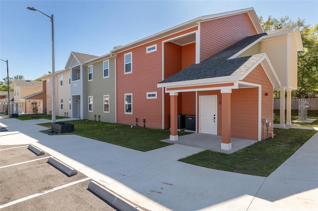1581 NW 29th Rd Unit 6, Gainesville, FL 32605 - view of building exterior with uncovered parking, a residential view, and central AC unit