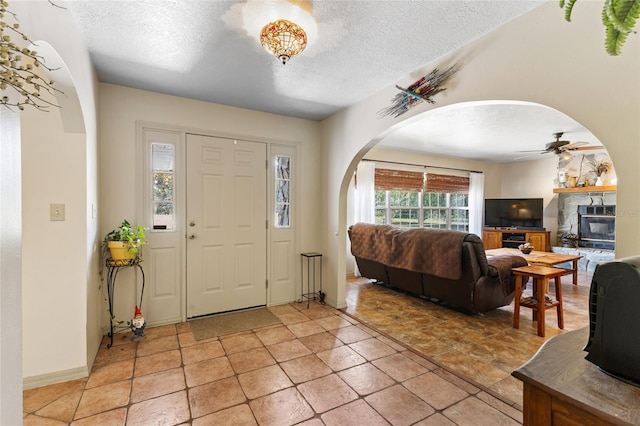 7450 SE State Road 121, Morriston, FL 32668 - foyer featuring arched walkways, a ceiling fan, and a textured ceiling