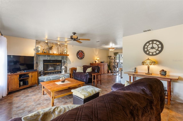 7450 SE State Road 121, Morriston, FL 32668 - living area featuring a ceiling fan and a stone fireplace