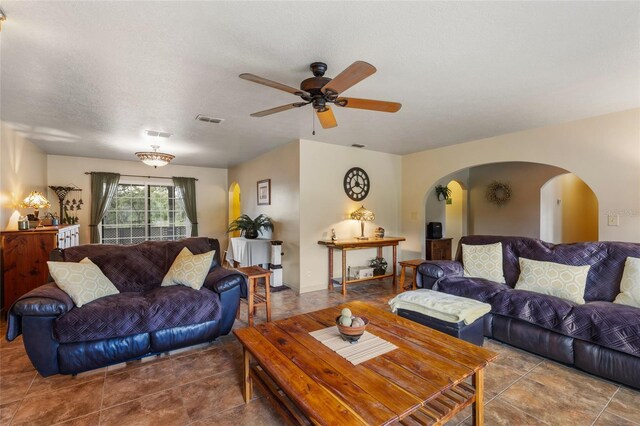 7450 SE State Road 121, Morriston, FL 32668 - tiled living room with arched walkways and a ceiling fan