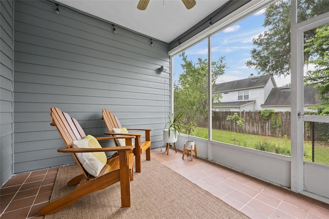 sunroom featuring ceiling fan