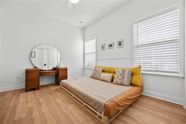 bedroom featuring wood finished floors, baseboards, and ceiling fan