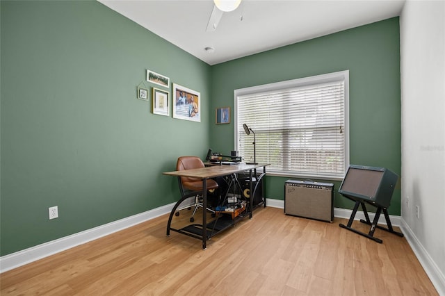 office area featuring light wood-style flooring, ceiling fan, and baseboards