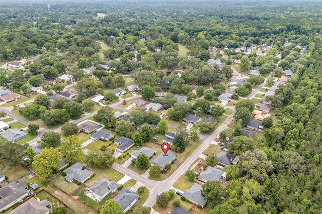 aerial view of residential area featuring a forest