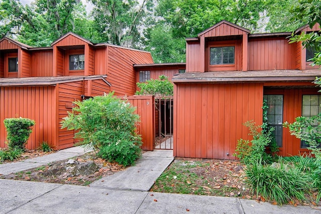 view of outbuilding featuring a gate and fence
