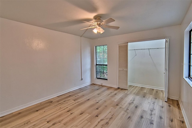 unfurnished bedroom featuring light wood-style floors, baseboards, a ceiling fan, and a closet