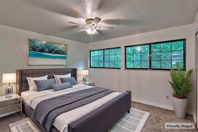 bedroom with carpet floors, ceiling fan, and baseboards